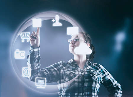 Woman pressing on a futuristic menu with icons.