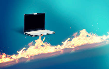 Laptop in front of a firewall suggesting cyber protection.の写真素材