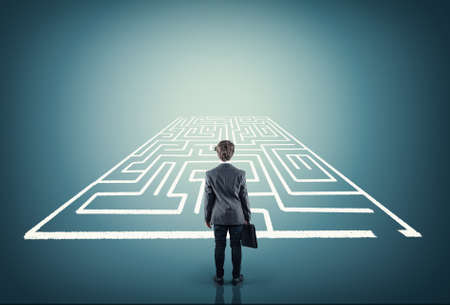 Businessman stands in front of a maze .の写真素材