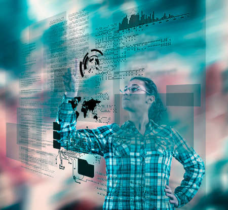 Woman using futuristic touch screen computer on colorful background.の写真素材