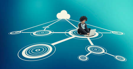 Man working on laptop in the middle of a network .の写真素材