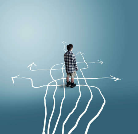 Confused man stands in front of different arrows . The concept of hard choices.