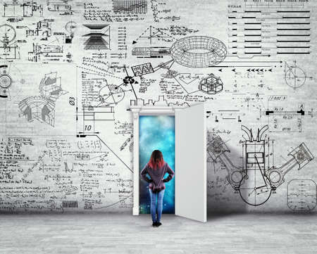 Woman standing in front of a wall drawn with math formlas and problems. Space behind the opened door.の写真素材