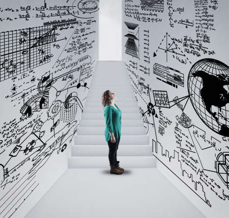 Woman  in a hallway drawn with math formulas and stairway to lightbulb .