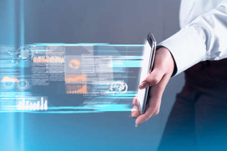 Hand holds a smartphone and transfering data.Futuristic technology concept.