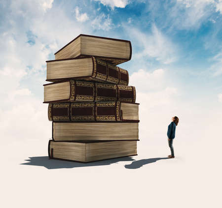 Young woman looks up to a tower of books.