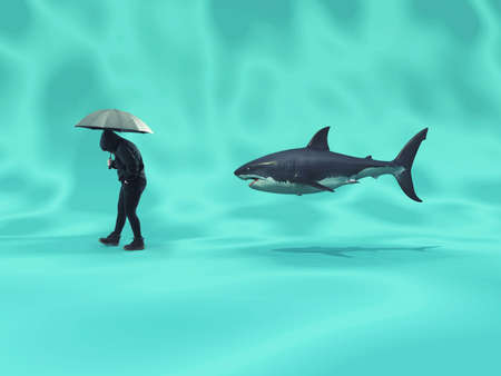 Person walks underwater holding an umbrella and followed by a shark. の写真素材