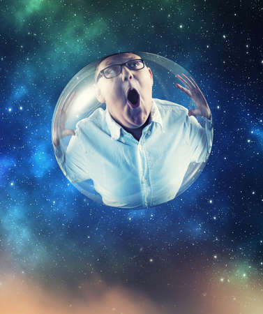 Kid in a bubble flying in space.の写真素材