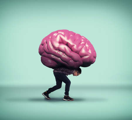 Kid carrying a brain on his back.の写真素材