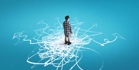Man standing on drawn arrows leading to different directions. The concept of variety of choicesの写真素材