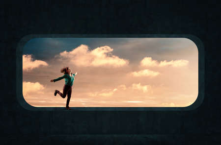 Young woman dancing on rounded concrete window and listen music . 