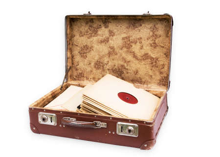 Old worn suitcase filled with old recordsの写真素材