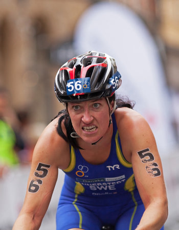 STOCKHOLM - AUG, 23:  World Triathlon  event Aug 23, 2014. woman bikes in Old town, Stockholm, Sweden. ÃSA ANNERSTEDT, SWEDEN.のeditorial素材