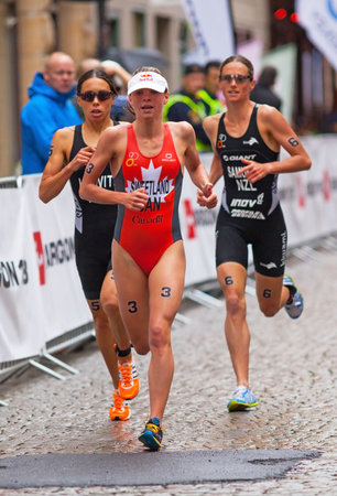 STOCKHOLM - AUG, 23:  World Triathlon  event Aug 23, 2014. woman running in Old town, Stockholm, Sweden. Andrea Hewitt NZL. Nicky Samuels, NZL. Kirsten Sweetland
, CAN.

のeditorial素材