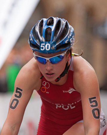 STOCKHOLM - AUG, 23:  World Triathlon  event Aug 23, 2014. woman bikes in Old town, Stockholm, Sweden. Magdalena Mielnik, POL.のeditorial素材
