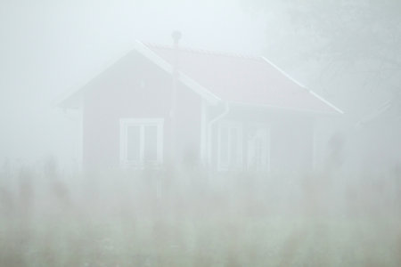 Little red cottage in strong fogのeditorial素材