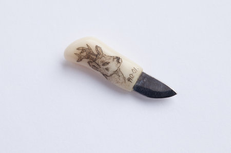 STOCKHOLM, SWEDEN, June 13, 2014: A very small handmade knife in bone and metal. Signed with the AO-01 and with an image of deer on the handle.のeditorial素材