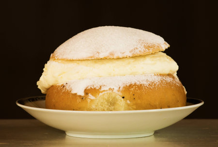 A typical Swedish cream bun filled with almond paste and creamの写真素材