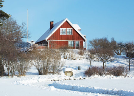 HOLO, SWEDEN FEBRUARY 06 2015. A little more modern red house by the ordinary variety for accommodation of a family., The house is located in the countryside in winter weather.のeditorial素材