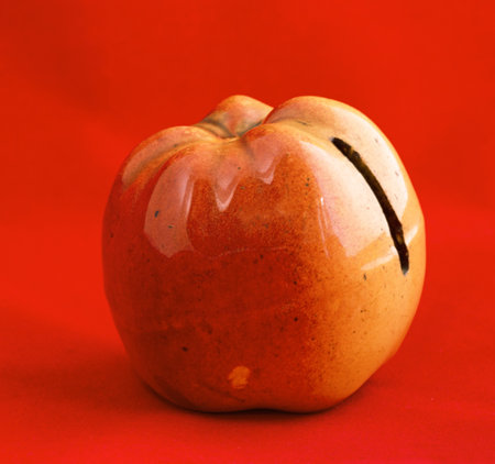 STOCKHOLM SWEDEN, FEBRUARY 20, 2015.  A porcelain apple, a money box for coins.のeditorial素材