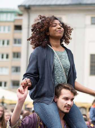 STOCKHOLM, SWEDEN - MAY 31, 2015. Peace and Love Parade. Street party in Stockholm, girl sitting on a man's shoulders.girl sitting on a man's shouldersのeditorial素材