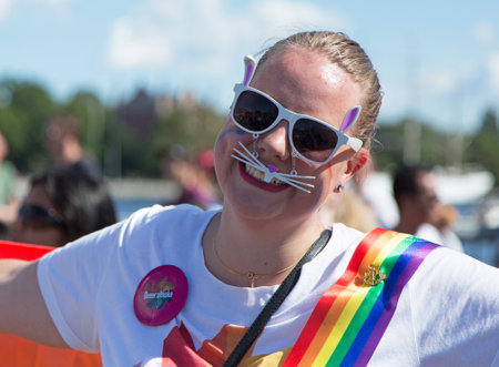 STOCKHOLM - AUG - 01. Stockholm Pride parade crossing the street with the name Skeppsbron 1 August 2015.のeditorial素材