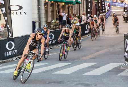STOCKHOLM - AUG, 22:  World Triathlon  event Aug 22, 2015. woman cycling in Old town. Hewitt, Andreaのeditorial素材