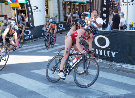 STOCKHOLM - AUG 22: Women ITU World Triathlon event Aug 22 2015. Woman cycling in Old town. Spirig, Nicola (SUI).のeditorial素材