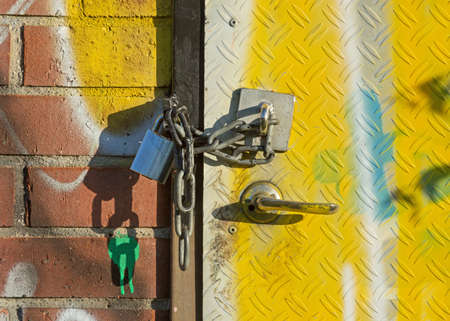 Old door with a padlock and chain