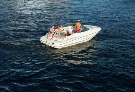 STOCKHOLM - AUG 15: A bunch of young guys lazing on a pleasure boatのeditorial素材