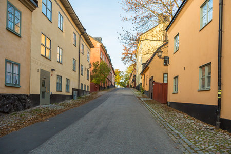 STOCKHOLM SWEDEN okt 31 2015: Stockholm district of Sodermalm, an empty street with yellow houses.のeditorial素材