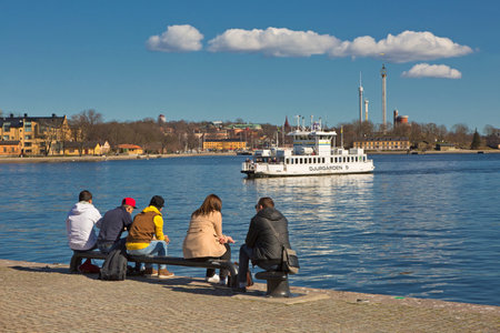STOCKHOLM SWEDEN 11 April 2016. Dormant people sitting on a bench in Stockholm.のeditorial素材