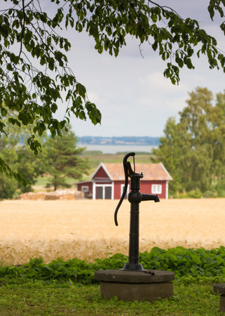VADSTENA SWEDEN 26 July 2016. A typical old water pump on the country which probably is not used anymore,のeditorial素材