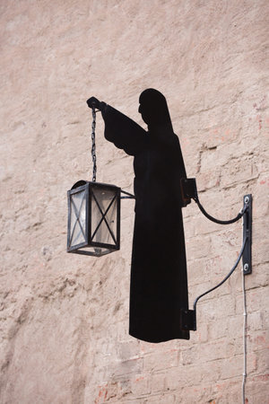 VADSTENA SWEDEN 26 July 2016. The sign of a nun holding a lantern.のeditorial素材