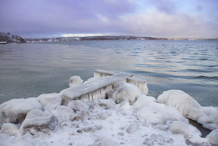 A small jetty frozen to iceの写真素材