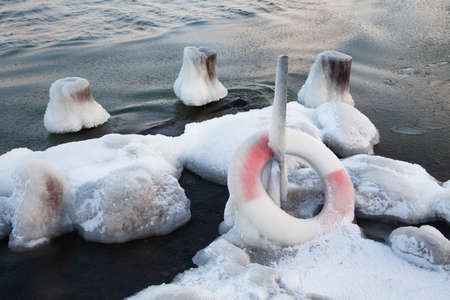 Lifebuoy frozen to iceの写真素材