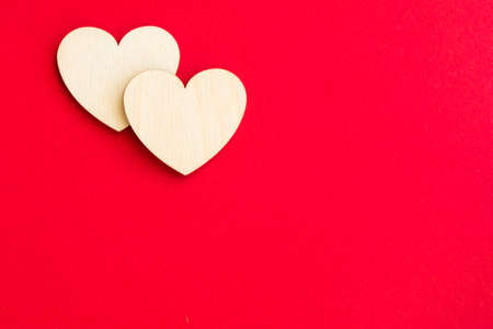 Wooden hearts on a red backgroundの写真素材
