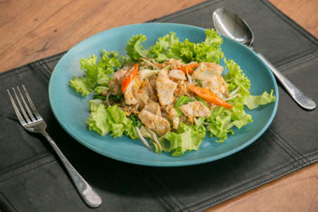 Stir fried Flat Rice Noodle with Soy Sauce and Pork 'Pad See Eww' on wooden table - Thai street foodの写真素材