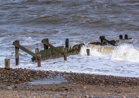 Groin sea defences with craching wavesの写真素材