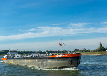 Dusseldorf, Rhineland, Germany, 09/15/2019 - the cargo ship Almenhof sailing along the river Rhine on a sunny day with blue skys.のeditorial素材
