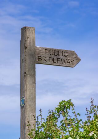 A wooden arrow directional public bridleway sign post for horse riders in the Yorkshire Wolds.の写真素材