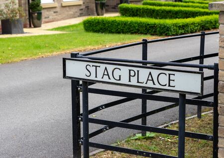 A UK street sign for a street called Stag Place mounted on poles, black with a white backgroundの写真素材