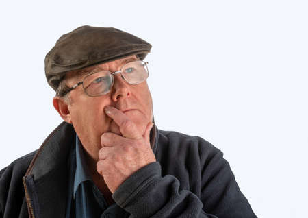 Portrait of middle aged man with facial expression, with blue shirt, glasses and hat with white background.の写真素材