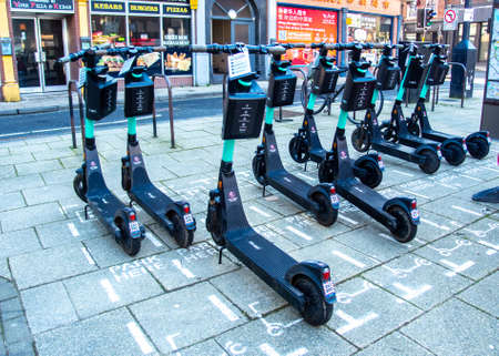 York, Yorkshire, UK, 01/02/2021 - Rented electric scooters parked on the sidewalk in the Ciry of...