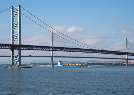 South Queensferry, Edinburgh, Scotland 7th September 2021 - A container carrying ship Anne Sibum passing under the Forth Road Bridges on a sunny day with clear sky.のeditorial素材