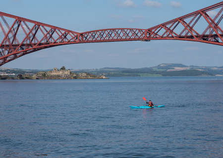 South Queensferry, Edinburgh, Scotland 7th September 2021 - A small blue Kayak on the River Forth at Queensferry on a sunny day with clear sky.のeditorial素材