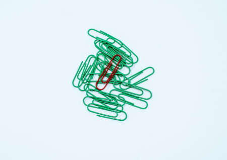 Multi coloured, red and green paper clips in a pile on a plain white background.の写真素材
