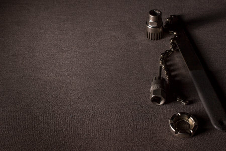 bicycle maintenance and repair tools on a dark background with a place for goods or text