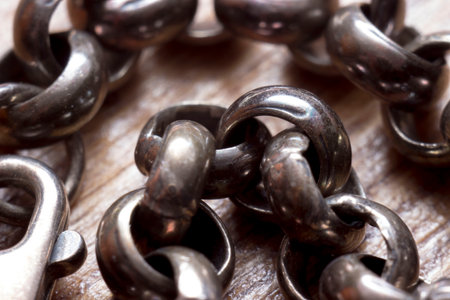 an old, tarnished silver metal chain with round links. close-up