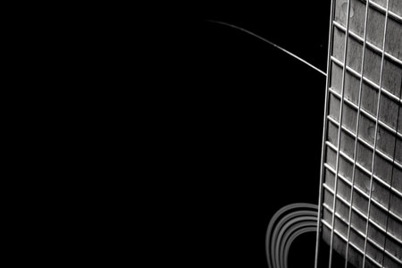 black acoustic guitar on a black background, silhouette. black and white, close-up, front side view